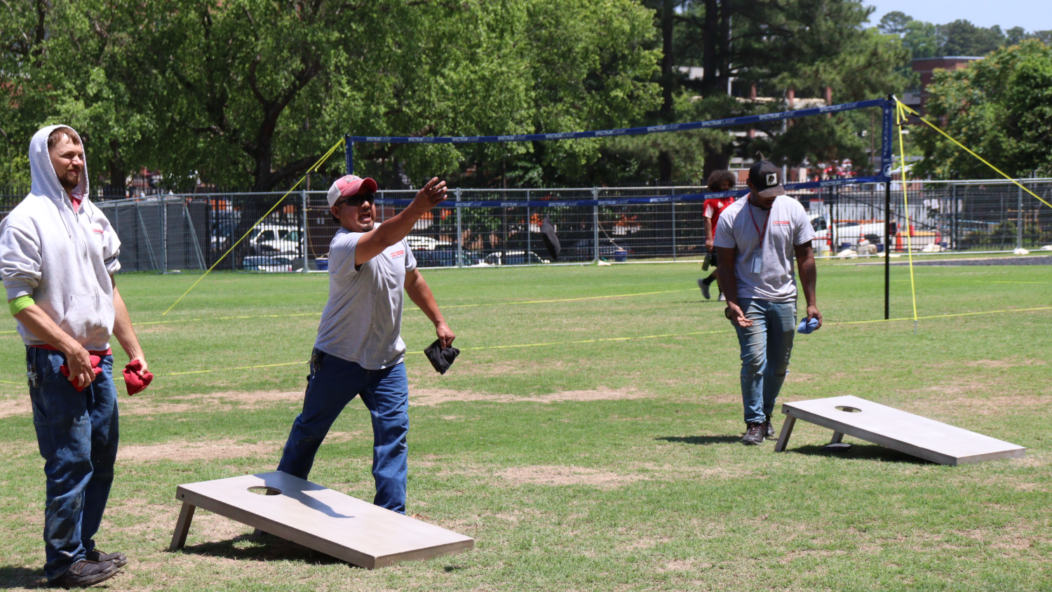 A group of NC State employees plays cornhole at Miller Fields during Employee Appreciation Week.