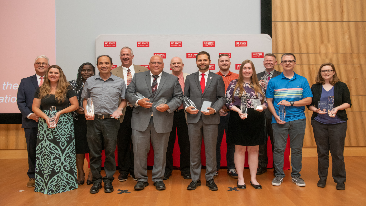 Chancellor Randy Woodson (back row, left) poses with the 2023 Award for Excellence winners. The winners (from left to right) are Karen Blaedow, Shannon DuPree, Jeffrey Luz, Vince Rogers, Steve Johnston, Bill Carlson, Connor Jones, Dan Spencer, Alyssa Jennings, Alan Porch, David Wagner and Kelsey Mills.