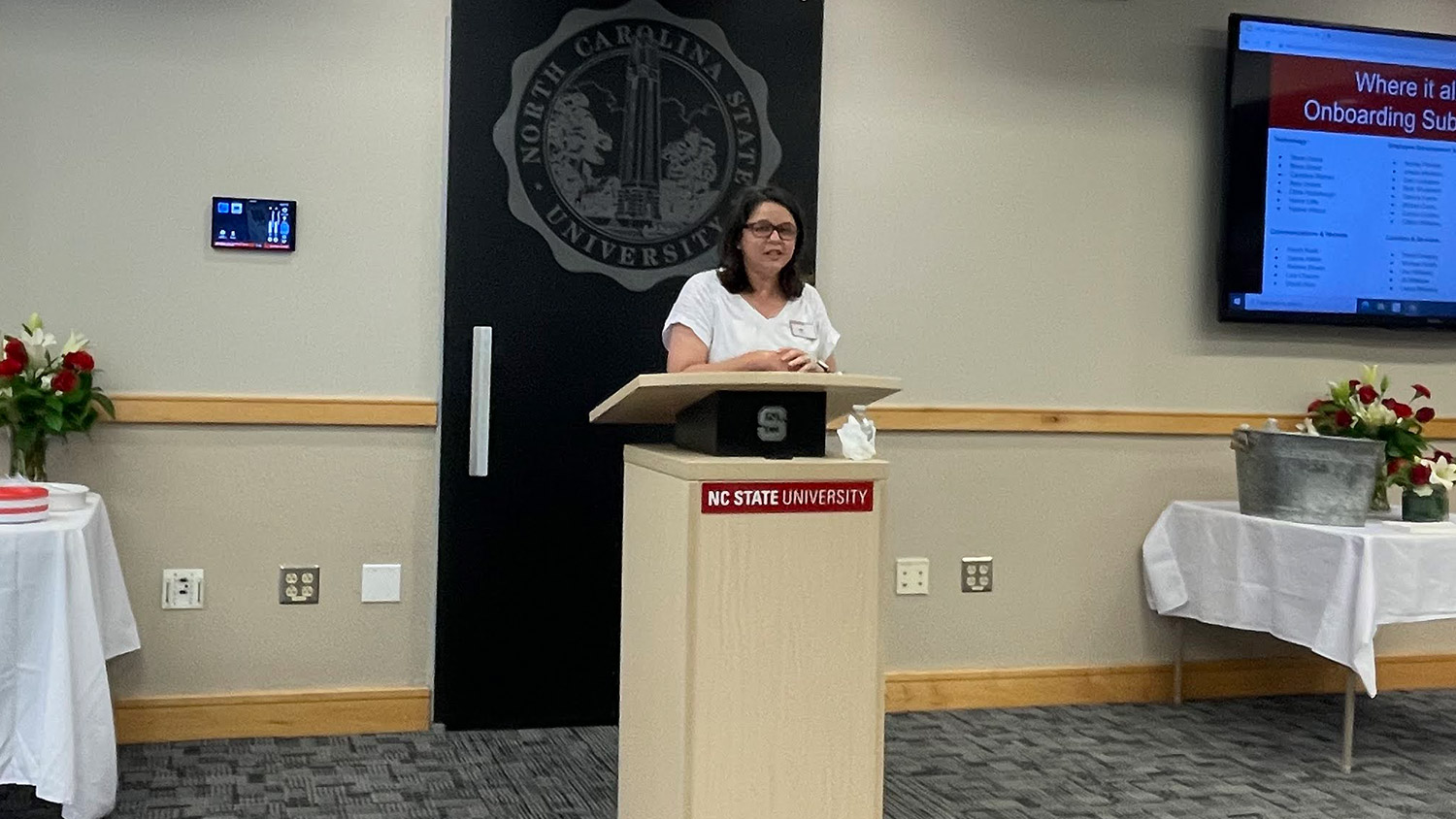 A picture of Amy Grubbs, manager of the NC State Onboarding Center, talking about the history of the center during its 10th anniversary celebration at the Joyner Visitor Center on June 14.