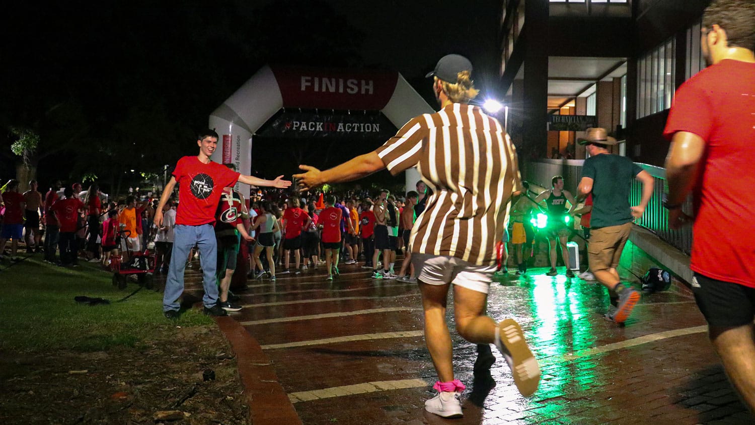 The picture shows runners participating in the Moonlight Howl and Run.